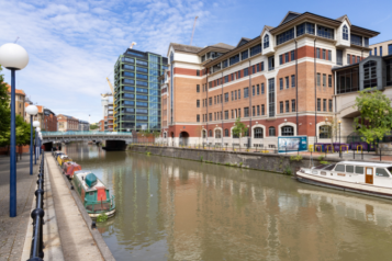A large, modern brick building overlooking part of the Feeder Canal