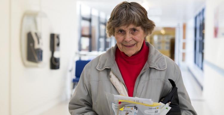 Older woman holding a packet of tablets