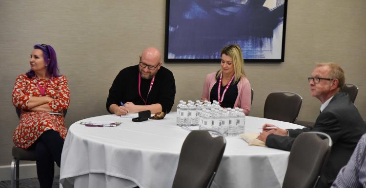 Participants sitting round a large table