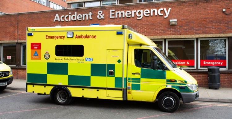 An ambulance parked outside a hospital A&E department