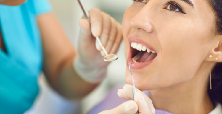 A white woman receiving dental treatment