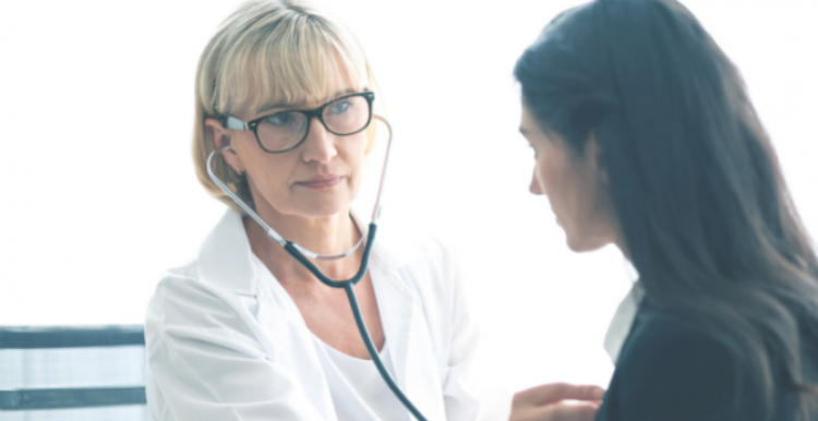 A doctor with a stethoscope listening to a patient's chest