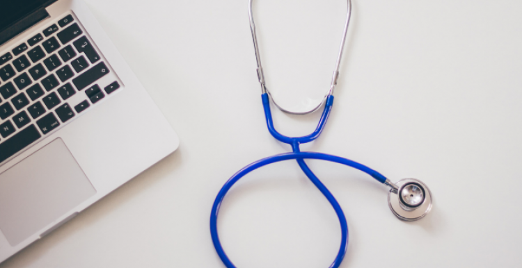 Image of a stethoscope and a laptop