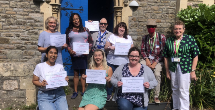 9 Healthwatch staff and volunteers holding certificates and smiling 9 Healthwatch staff and volunteers holding certificates and smiling