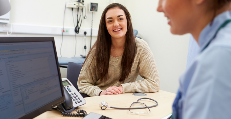 A teenager talking to a school nurse