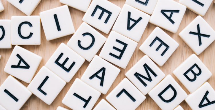 A jumble of white tiles with black letters on them