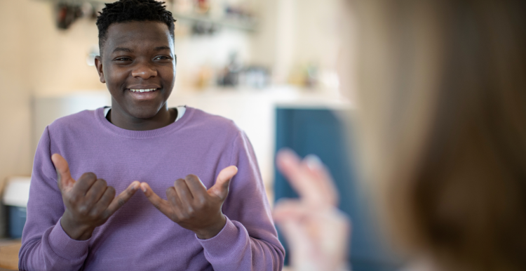 Two people having a conversation using sign language