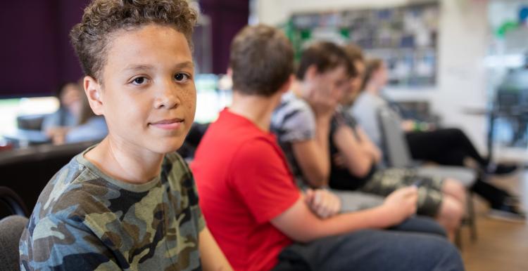 Teenage boy sat with his friends