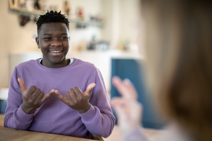 Two people having a conversation using sign language Two people having a conversation using sign language