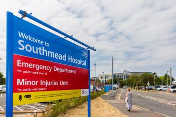 Signs for the Emergency Department and Minor Injuries Unit at the entrance to Southmead Hospital.