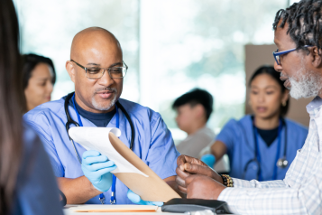 Doctors talking to patients at a community health clinic.