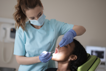 A dentist examining a patient.