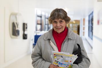 Older woman holding a packet of tablets