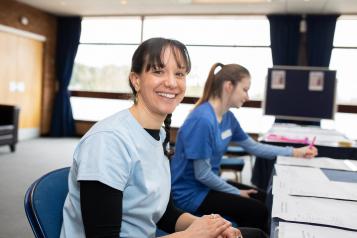 Two nurses working at computers