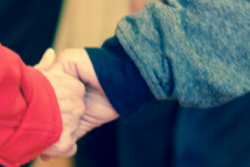 Close-up of two people holding hands