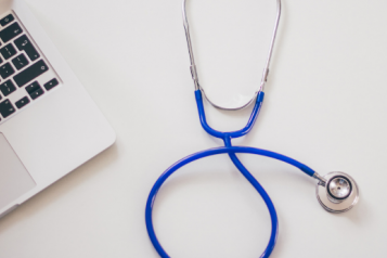 Image of a stethoscope and a laptop
