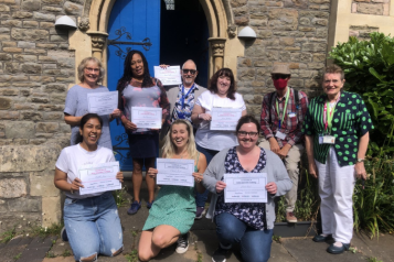 9 Healthwatch staff and volunteers holding certificates and smiling 9 Healthwatch staff and volunteers holding certificates and smiling