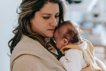 A mother holding her young baby