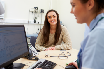 A teenager talking to a school nurse