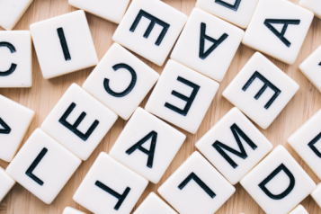 A jumble of white tiles with black letters on them