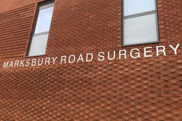 A brick building. Sign reads 'Marksbury Road Surgery'