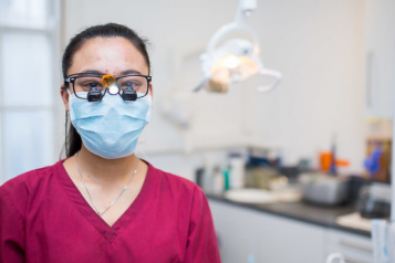 Woman in red scrubs wearing PPE