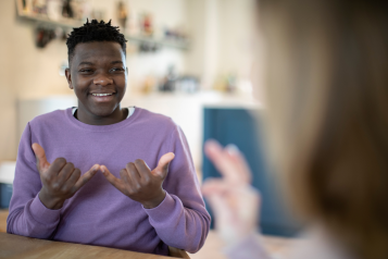 Two people having a conversation using sign language