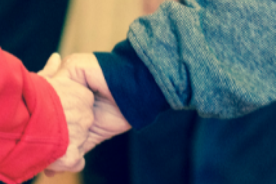 Close-up of two people holding hands