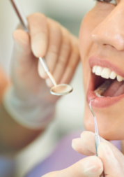 A white woman receiving dental treatment