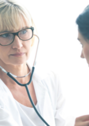 A doctor with a stethoscope listening to a patient's chest