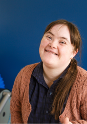 A young woman with a learning disability smiling